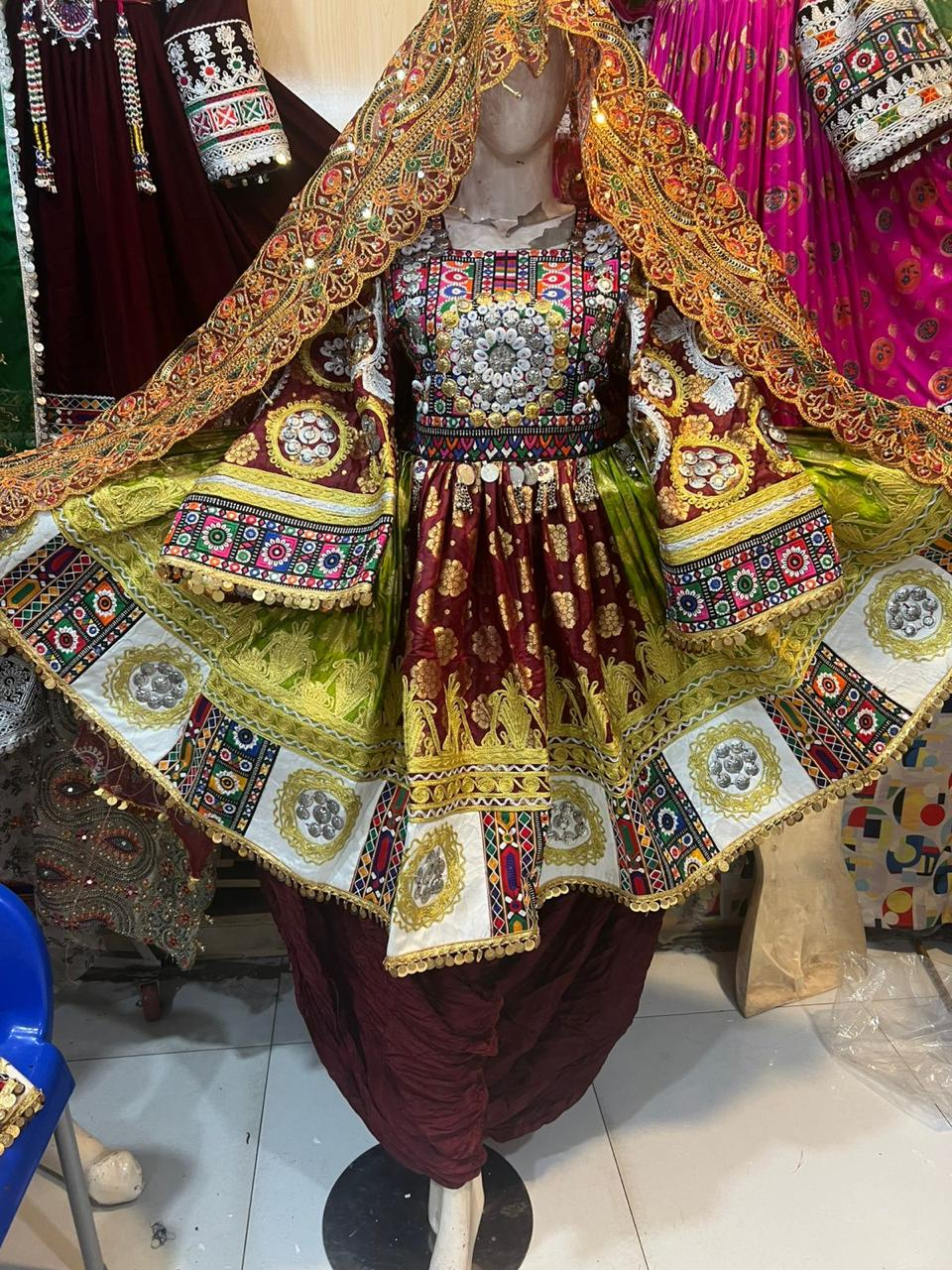 Afghan bridal dress in maroon and gold with olive green dupatta on mannequin