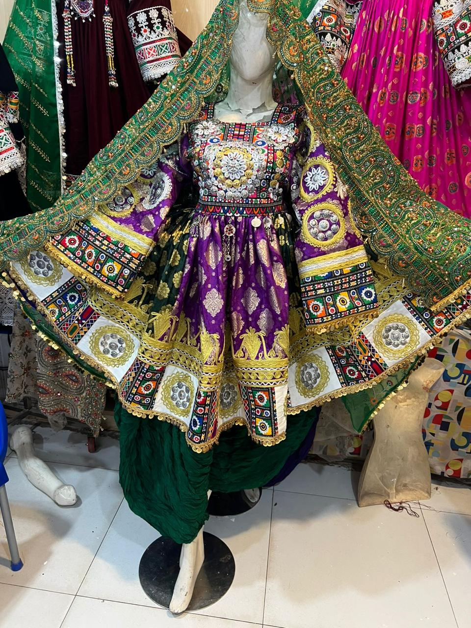 Afghan bridal dress in royal purple with green dupatta and gold embroidery on mannequin