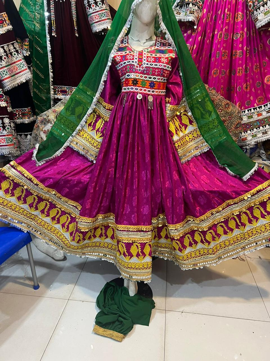 Afghan bridal dress in magenta with green dupatta and mirror work embroidery on mannequin